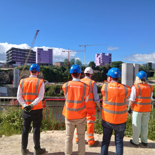 People in highvis on a site tour of the New Wear high-level Footbridge.