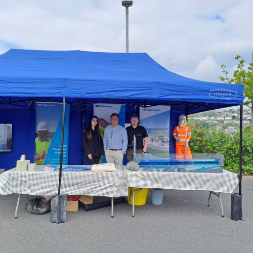 People stood outside under a gazebo at a careers fair.