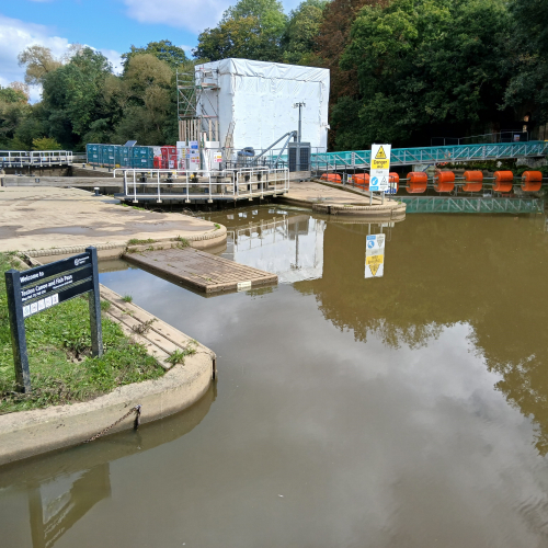 Picture of a cabin next to a pond.
