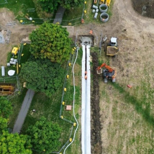 Picture of a field with a dumper truck.