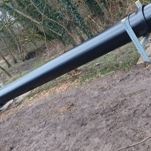 Picture of a black pipe in the woods.