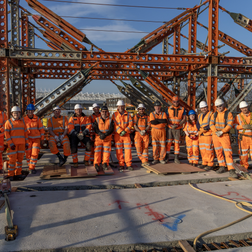 Team of construction works stood on top of the New Wear footbridge