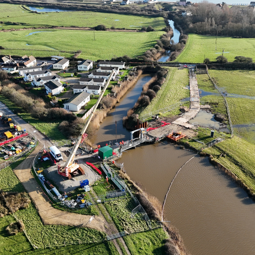 Aerial view of work taking place over a river