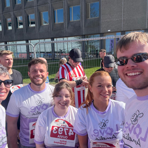 Picture of five people smiling in the sun