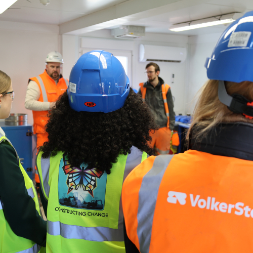 Girls in PPE listening to a presentation.