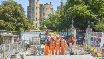 Picture of VolkerHighways employees in orange PPE, on site and smiling.