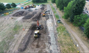 Picture of a field with a dumper truck.