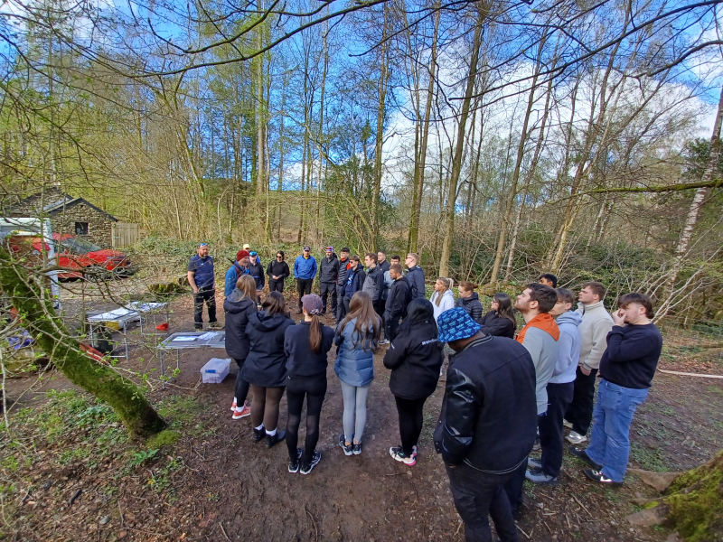 A group of people stood in the woods