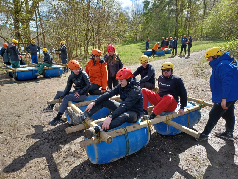 Group of people sat in a homeade raft