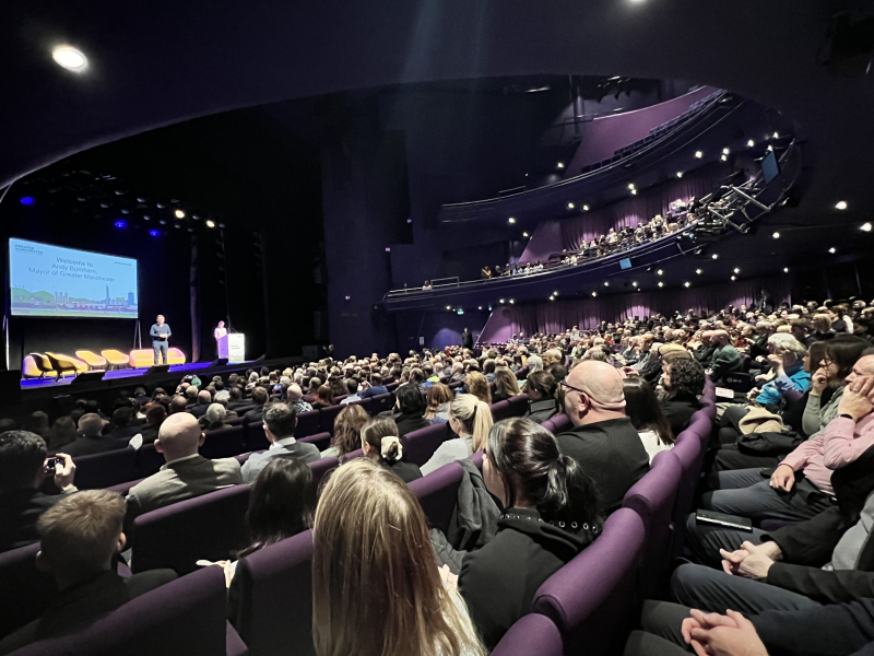 People sat in a theatre auditorium