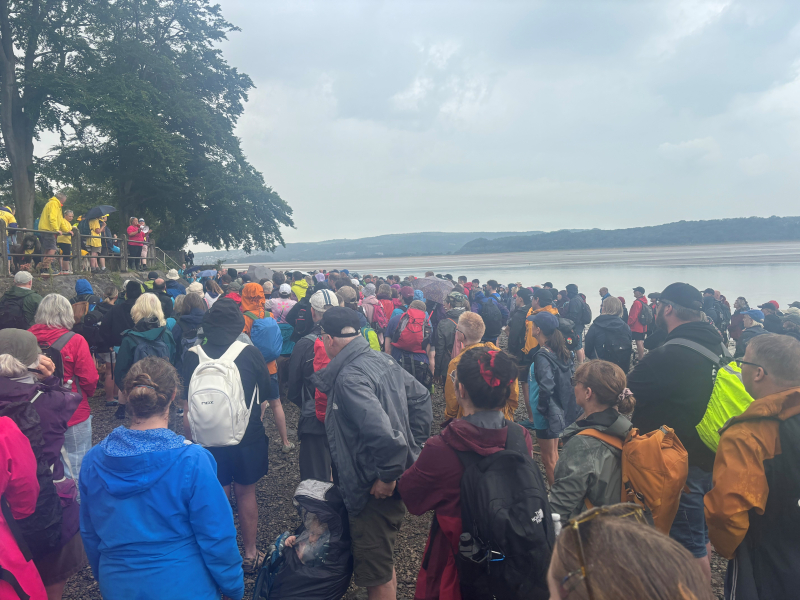 group of walkers stood on a beach
