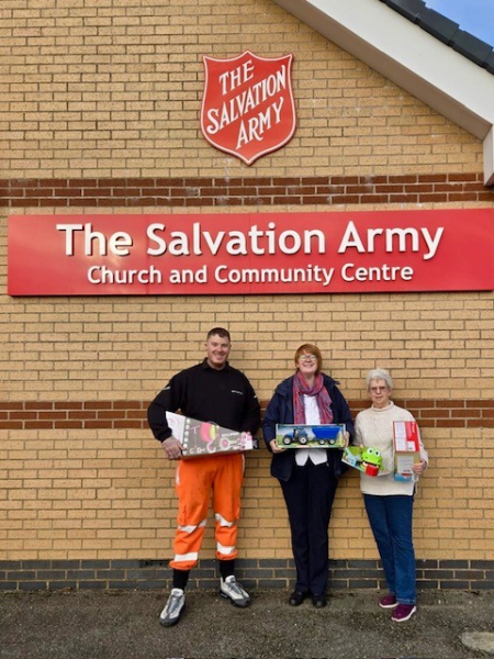 People stood with gifts for a charity.