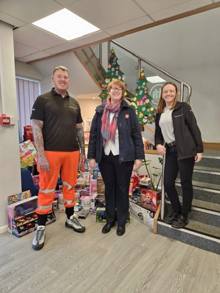 People stood with gifts for a charity.