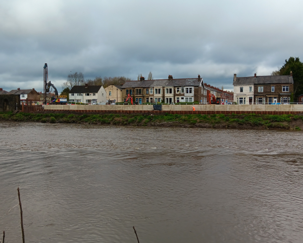Picture of new wall units installed along Riverside, with houses in the background.