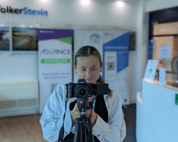 Picture of girl filming with a camera.