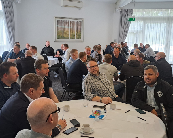 People sat around tables at an event.