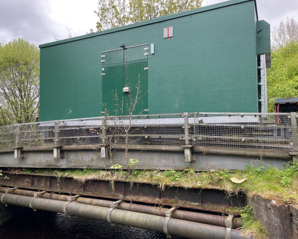 A kiosk being driven over a bridge