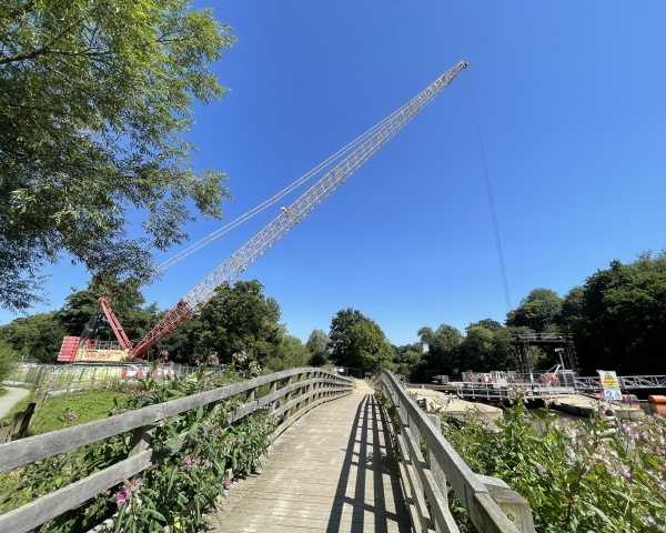 Picture of a crane going over a field.