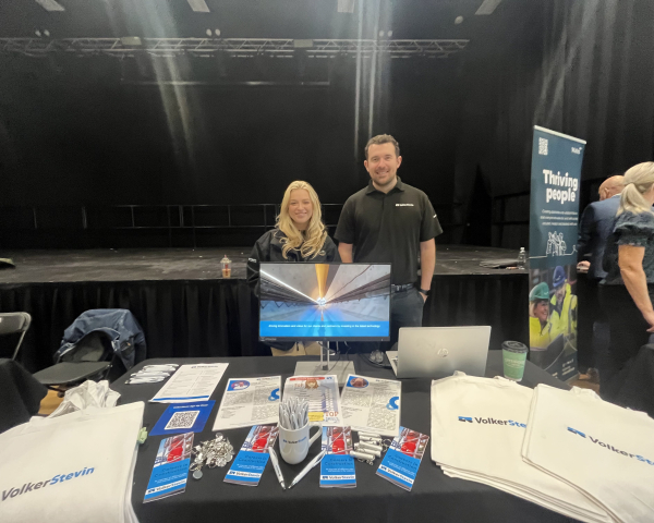 Man and women stood behind table with brochures and leaflets on