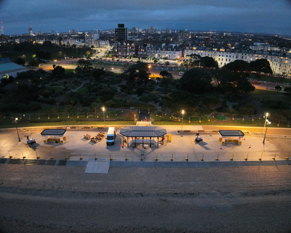 Southsea promenade lit up in the evening showing shelters