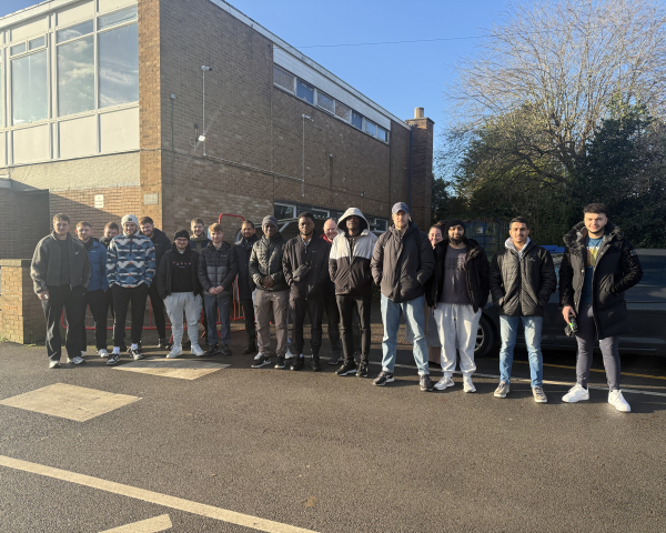Group of men and women outside a construction site