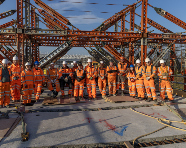 Team of construction works stood on top of the New Wear footbridge