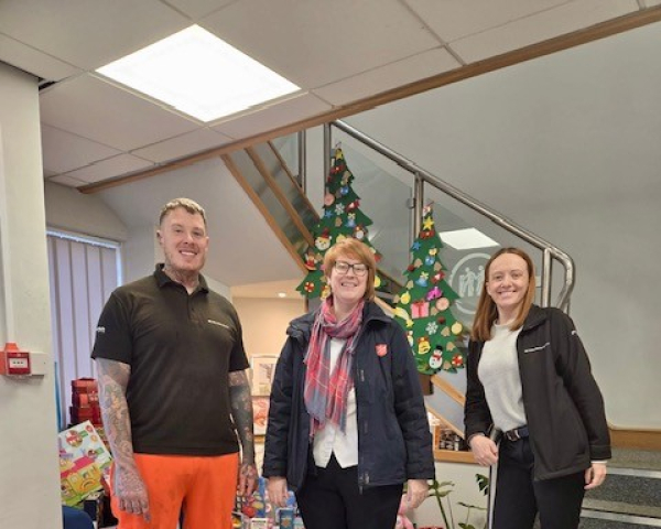 People stood with gifts for a charity.