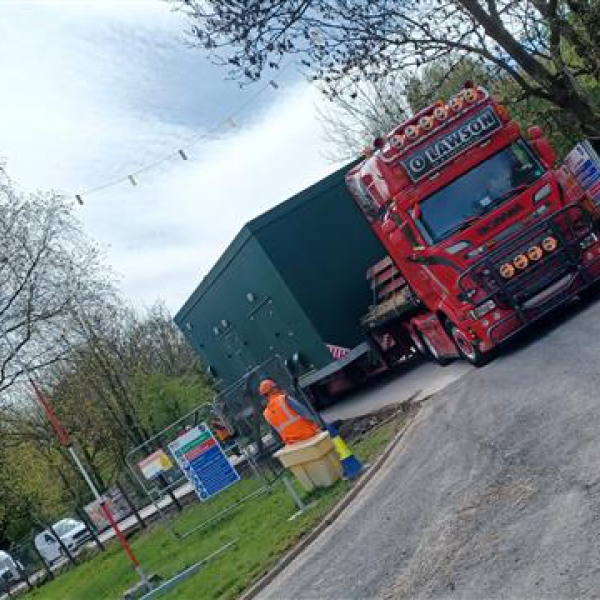 Truck delivering a new kiosk to site.