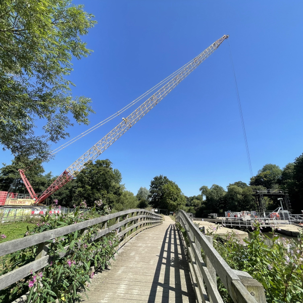Picture of a crane going over a field.