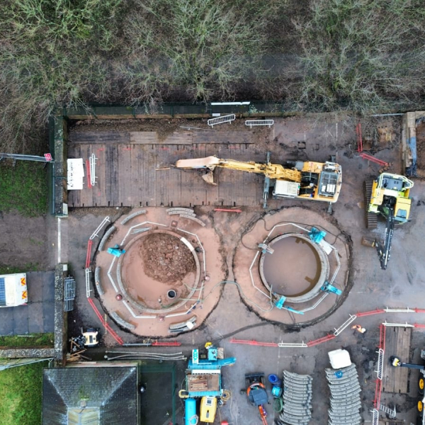 Picture of two diggers next to two large holes.