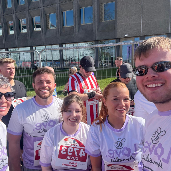 Picture of five people smiling in the sun