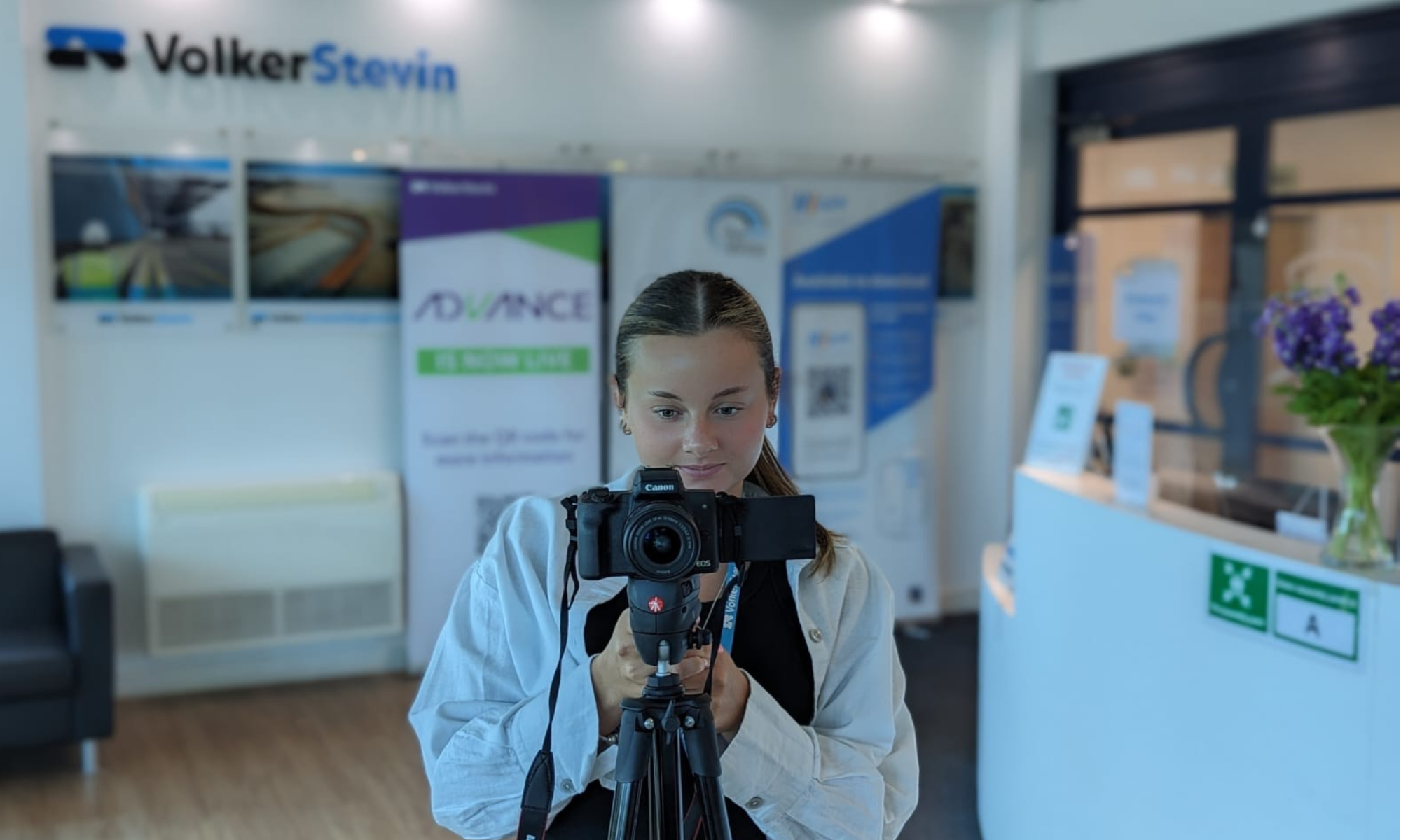 Picture of girl filming with a camera.