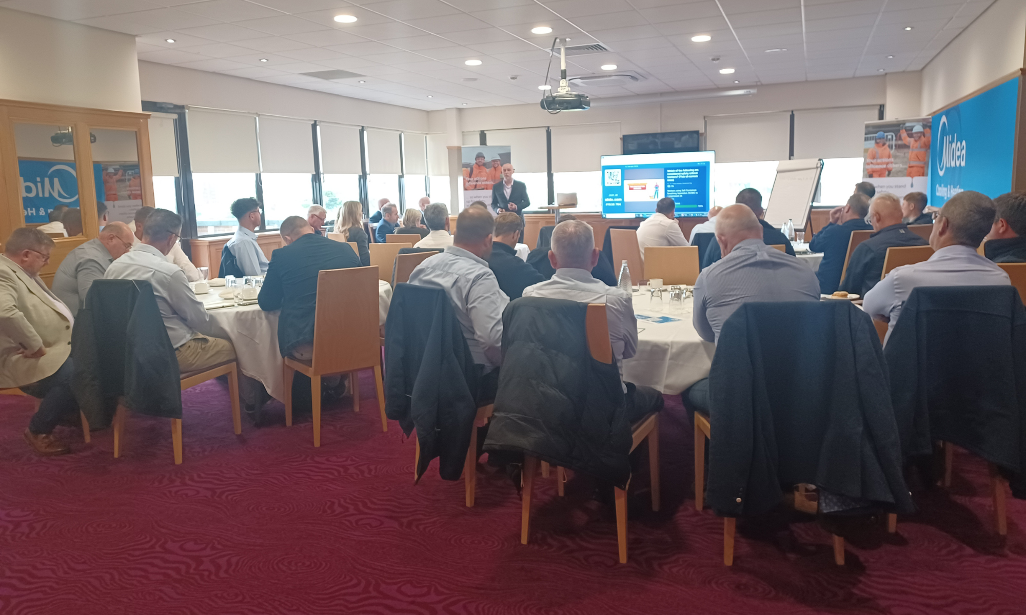 People sat around tables at an event.