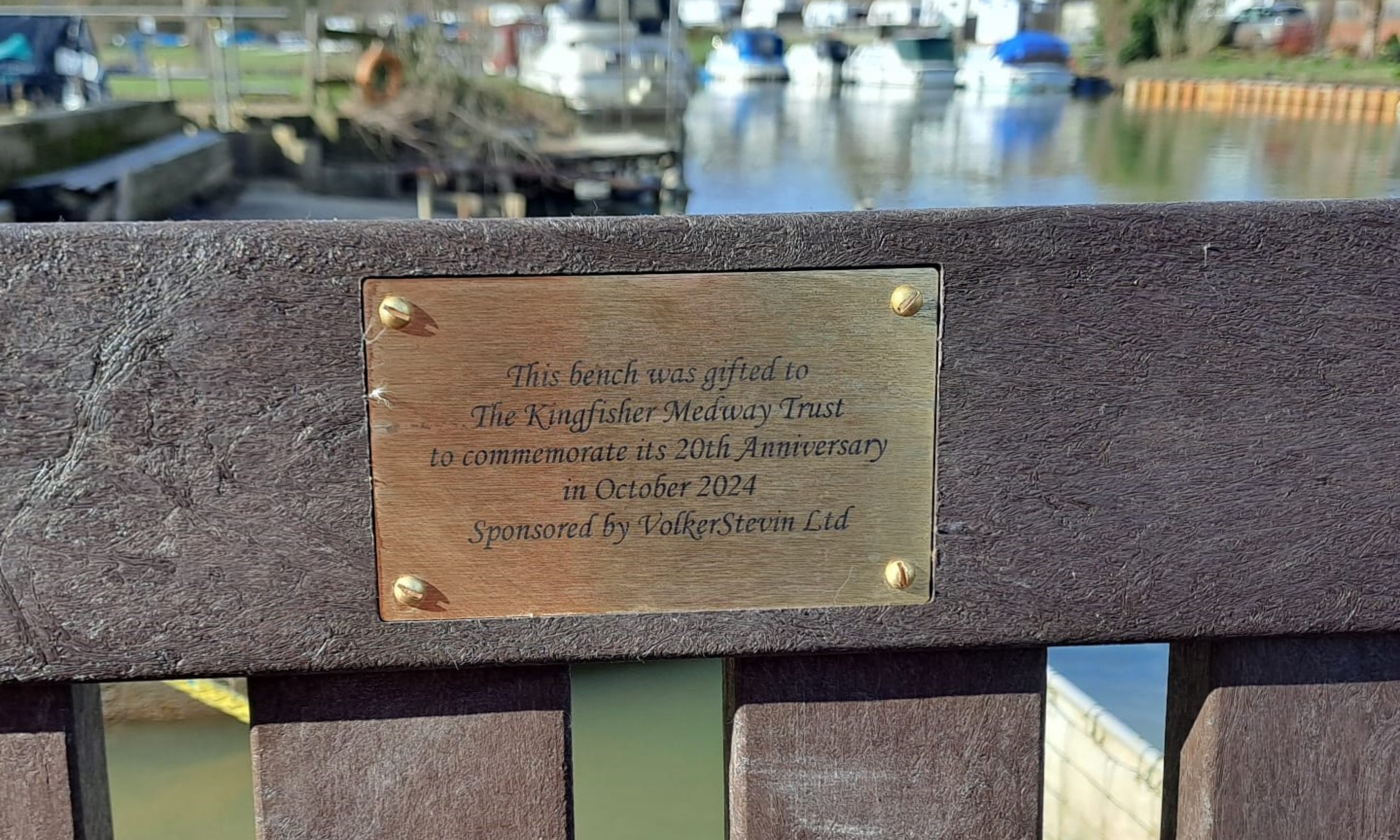 Picture of a plaque on a bench 