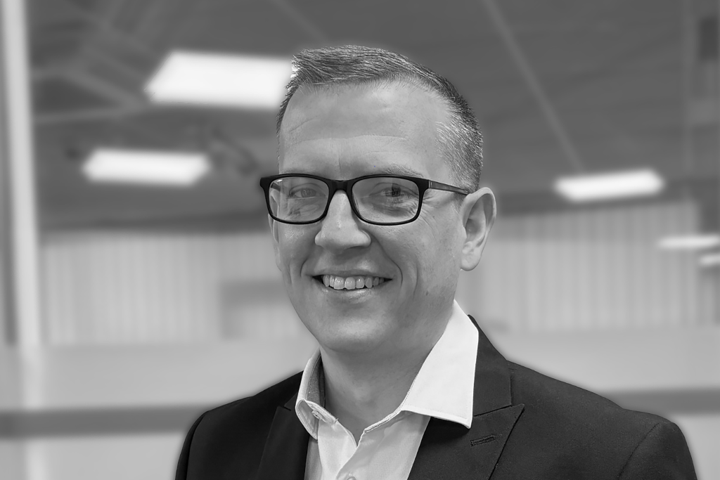 Headshot of David Coyle in black and white